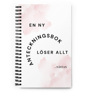 Notebook med texten "En ny anteckningsbok löser allt" – spiralbunden med prickade sidor.