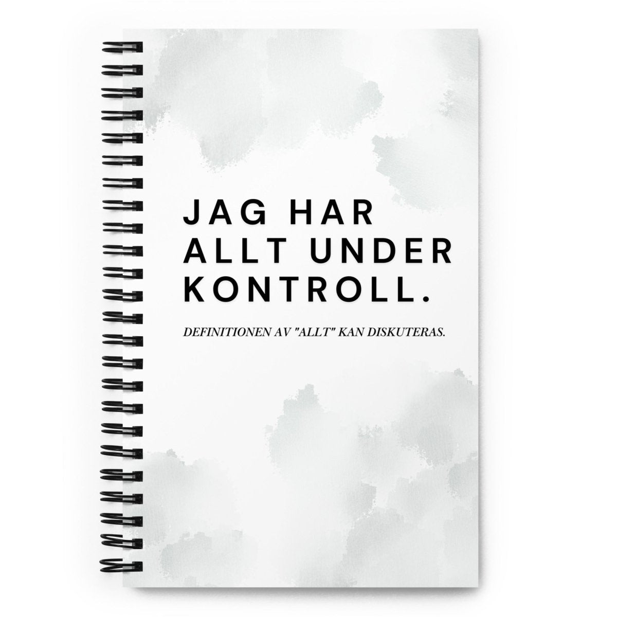 Notebook med texten "Jag har allt under kontroll, definitionen av allt kan diskuteras" – spiralbunden med prickade sidor.